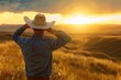 © gankevstock - Cowboy watching sunset over rolling hills, feeling of freedom and adventure