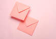 Square paper pink envelopes on pink background
