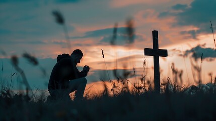 Wall Mural - Christian man praying in front of the cross