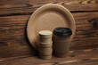 Disposable eco consumables for cafe and delivery on wooden background