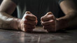 Close up of hands with fists on the table, ready to fight. conflict, angry expression