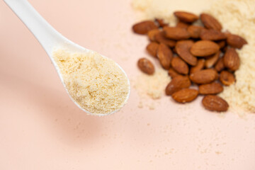 Wall Mural - Almond flour and almonds on a beige background
