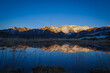 Sunset over the Pyrenees mountains with the reflection of the peaks in the water of the lake High quality 4k footage
