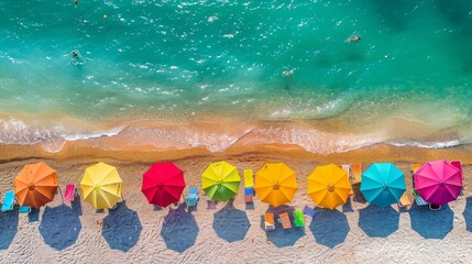 Canvas Print - Top view of Beach of colorful umbrellas dotting the shoreline, lively and picturesque scene.