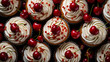 Overhead view of cupcakes topped with piped buttercream, white chocolate flakes and Maraschino cherries
