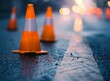 photo of traffic cones on asphalt in a parking lot, with the focus on the cone in front, taken outdoors during the day