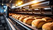 Automated bakery production line with bread loaves on conveyor belt for efficient manufacturing