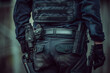 Tactical police gear with gun, baton, and handcuffs