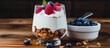 A dish of yogurt topped with raspberries and blueberries on a wooden table. A refreshing and healthy food option with a mix of fruits as ingredients