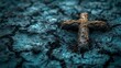   A cross lying on the ground, surrounded by dirt
