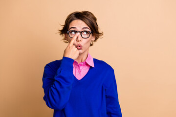 Sticker - Photo portrait of lovely young lady look empty space fix specs wear trendy blue garment isolated on beige color background