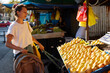 © Boris Jovanovic/Stocksy - Portrait of a woman choosing fruit at the market
