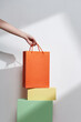 © Marc Tran/Stocksy - A bunch of shopping bags on colorful cardboard boxes