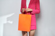 © Marc Tran/Stocksy - Great day shopping. Cropped image of a woman holding shopping bags.