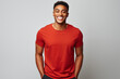 © Pierre - Studio portrait of smiling young black man with red t-shirt and grey background.