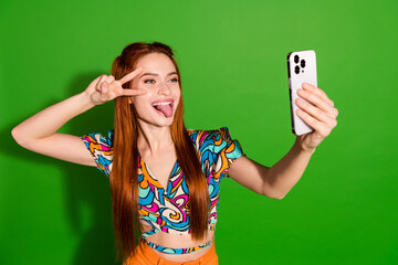 Canvas Print - Photo portrait of attractive young woman v-sign tongue out selfie photo dressed stylish retro clothes isolated on green color background