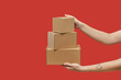 © Yaroslav Danylchenko/Stocksy - Woman's hands carrying three cardboard boxes in stack
