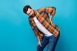 Photo portrait of nice young guy touch back need painkiller wear trendy plaid garment isolated on blue color background