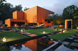 A modern, cube-shaped house with a bright orange exterior, set against a meticulously groomed lawn with geometric landscaping elements. It includes an outdoor fireplace, 