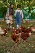 © Iuliia Versta/Stocksy - children feed the chickens