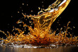 A splash of yellow liquid on black background. Honey, caramel or oil is splashing on wet surface.