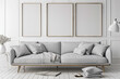 A modern, Nordic-style lounge with a light gray couch and white frames, offering a canvas for creativity.