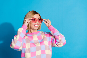 Sticker - Photo portrait of pretty young girl touch sunglass celebrate look empty space wear trendy pink outfit isolated on blue color background