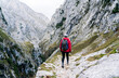 © Daniel Gonzalez/Stocksy - Unrecognizable traveler in outerwear strolling in highlands
