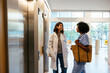 © BONNINSTUDIO/Stocksy - Healthcare workers waiting elevator at hospital