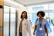 © BONNINSTUDIO/Stocksy - Healthcare workers going to elevator at hospital