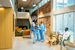 © BONNINSTUDIO/Stocksy - Medical workers in hospital hall