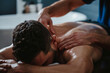 Therapist giving a deep tissue back massage to a man