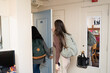 © Lea Jones/Stocksy - college students walking out of dorm room heading to class