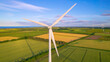 AERIAL, CLOSE UP Rotating wind turbine on a wind farm in the English countryside