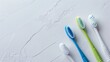 Positioned on a white paper background is a new toothbrush featuring green, white, and blue colors, highlighting dental hygiene.