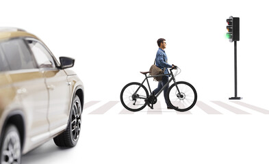 Wall Mural - Full length profile shot of a guy pushing a bicycle in front of a car at a pedestrian crossing