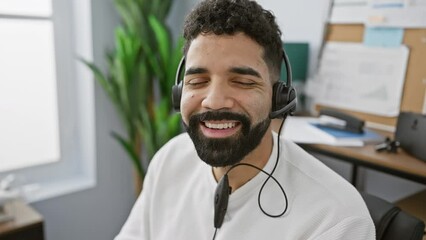 Sticker - Smiling bearded man wearing a headset in a modern office with a drone on the desk