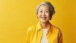 Elderly asian woman in clean background for copyspace template. Adult middle-aged female person. Cheerful happy portrait