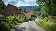 An active cyclist rides along a picturesque village road flanked by historical timbered houses and blooming flora
