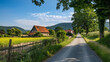 A serene view showcasing a quiet road lined with lush trees leading to rustic houses in rural countryside