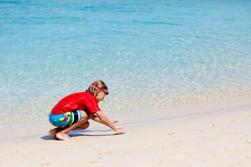 Wall Mural - Kids playing on beach. Children play at sea.