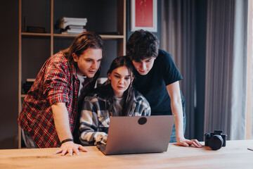 Poster - A close-knit group of friends shares a moment together in front of a laptop at home, demonstrating friendship and togetherness.