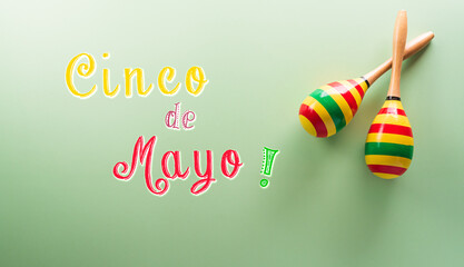 Wall Mural - Cinco de Mayo holiday background made from maracas and the text on pastel background.