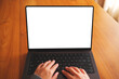 © Farknot Architect - Top view mockup image of a woman working and typing on laptop computer with blank screen on wooden table