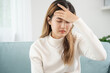 © Shisu_ka - Headache, female having migraine pain, bad health, Asian woman feeling stress and headache, Office syndrome, sad tired touching forehead having migraine or depression, irritated girl, sadness grief