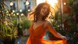 Portrait of carefree young woman dancing in orange dress