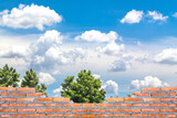 Fototapeta  - brick wall with blue sky cloudy