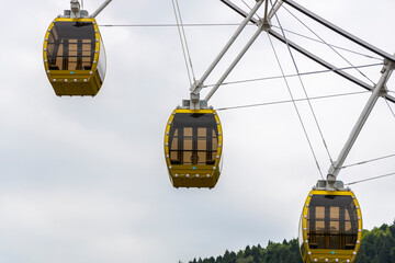 the skyscrapers in the amusement park hang high and spin in the sky