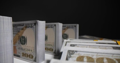 Wall Mural - Stacks of dollar banknotes arranged on desk showing domino effect