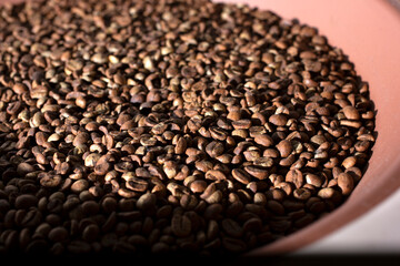 Wall Mural - A closeup view of a pile of medium roast coffee beans.